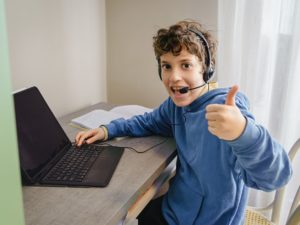 Kid with laptop and headset